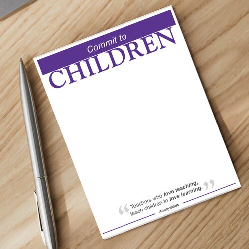 commit to children notepad and silver pen sitting on a desk