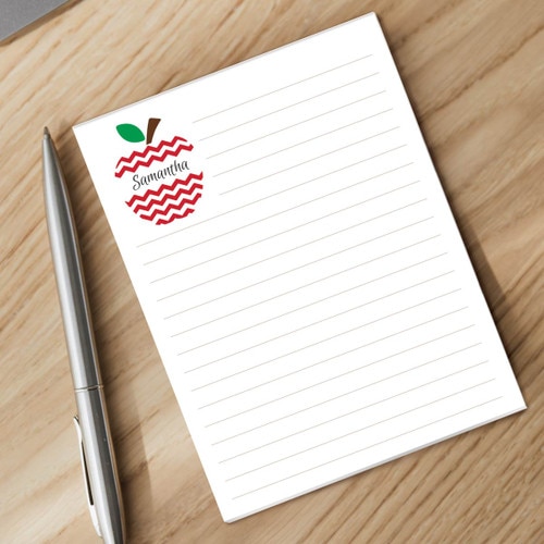personalized chervon apple notepad and silver pen sitting on a desk