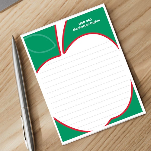 personalized apple notepad and silver pen sitting on a desk