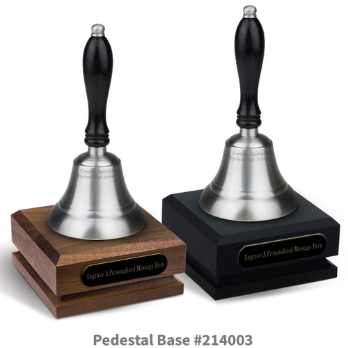 black and a brown walnut pedestal bases with black brass plates and pewter bells