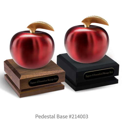 black and a brown walnut pedestal bases with black brass plates and crimson finished brass apples
