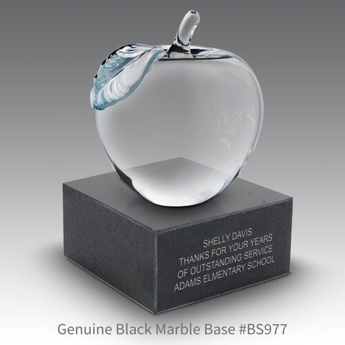 crystal apple sitting on top a black marble base