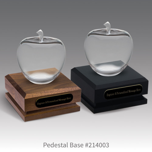 black and a brown walnut pedestal bases with black brass plates and optic crystal apples