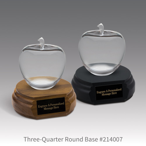 black and a brown walnut three-quarter round bases with black brass plates and optic crystal apples