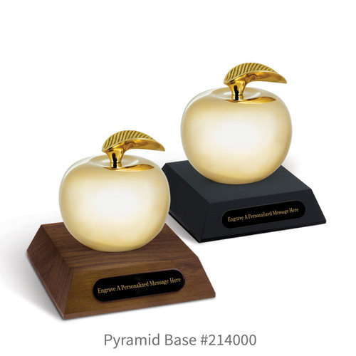 black and a brown walnut pyramid bases with black brass plates and brass apples