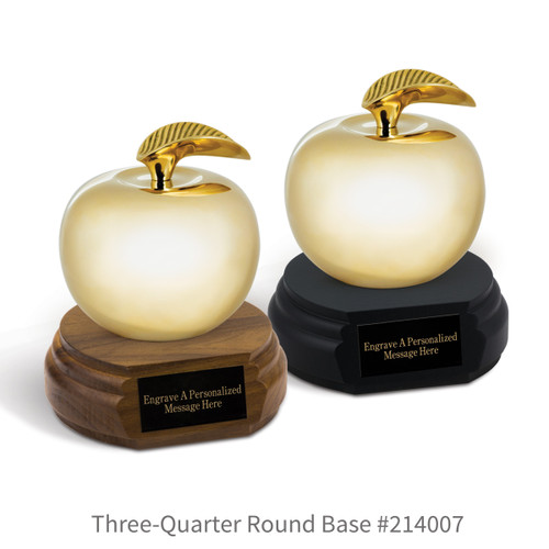 black and a brown walnut three-quarter round bases with black brass plates and brass apples