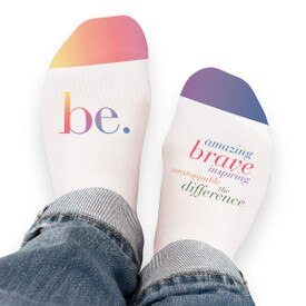 Pair of no-show socks with a colorful Be The Difference message on top.