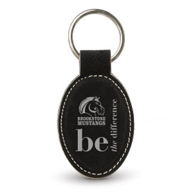 black oval leather keychain with be the difference message and logo