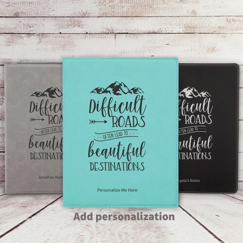gray, teal, and black leather padfolios featuring Beautiful Destinations message