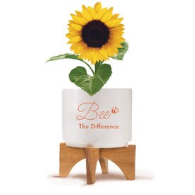 Two-piece bamboo stand with modern white ceramic planter featuring the inspirational message “Bee The Difference.” Grows sunflowers.