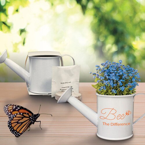 forget-me-nots in mini watering can with a butterfly