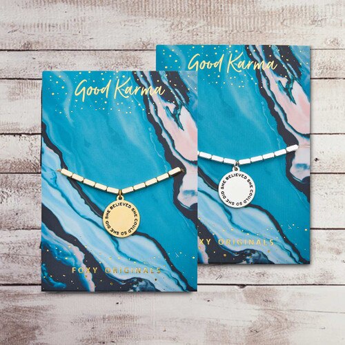 gold and silver bracelet with “She Believed She Could So She Did” message