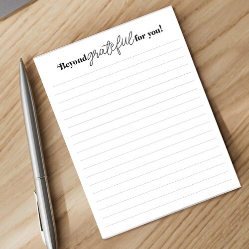 beyond grateful notepad and pen sitting on a desk