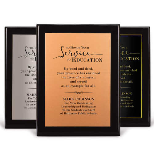 three black piano finish plaques with service to education message and personalizated copper, silver and black plates