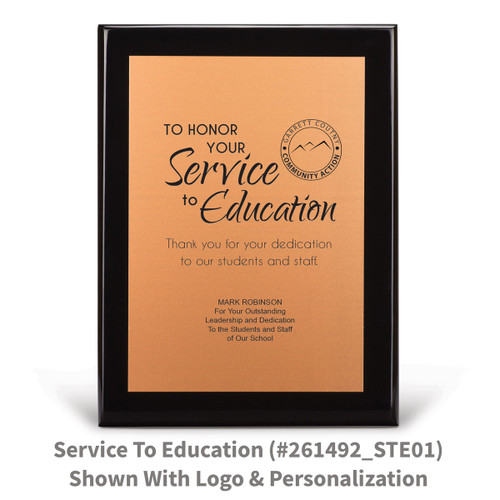 black piano finish plaque with service to education message and a personalized copper plate