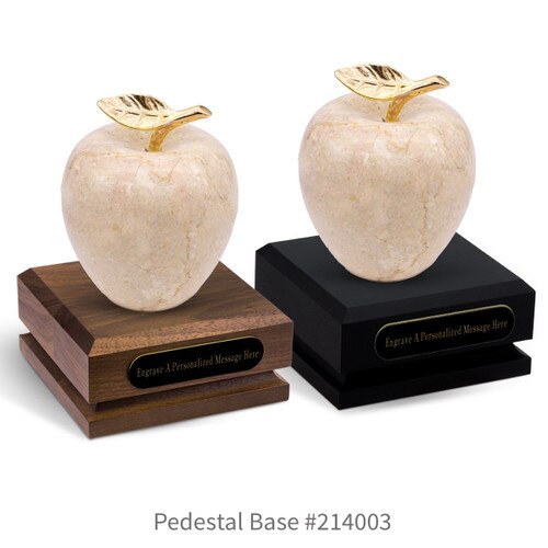 black and a brown walnut pedestal bases with black brass plates and botticino beige marble apples