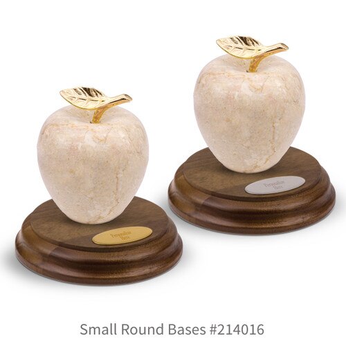 round walnut bases with brass and silver plates and botticino beige marble apples