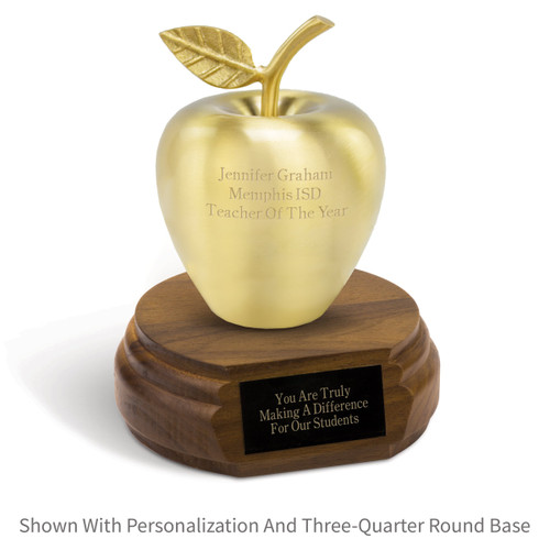 personalized brushed gold apple sitting on a walnut base with black brass plate