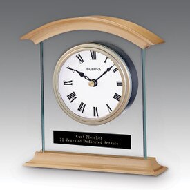 Bulova Bristol Clock featuring brushed brass metal, thick glass, and bold Roman numerals.