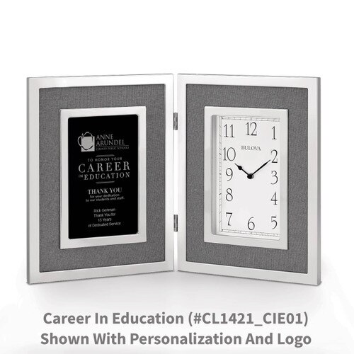 large silver framed clock with career in education message