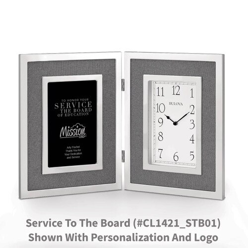 large silver framed clock with service to the board message