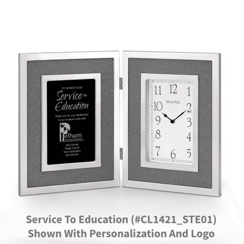 large silver framed clock with service to education message