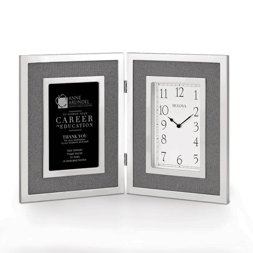 large silver framed clock with career in education message