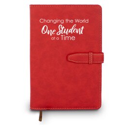 Hardbound journal with tab and loop closure. Cover reads: Changing The World One Student At A Time