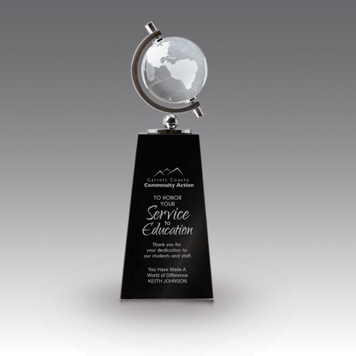 crystal globe sits atop a black crystal base with service to education message