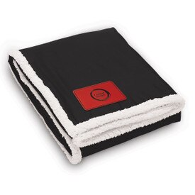 Black Sherpa blanket featuring a customizable patch. Measures 50x60 inches unfolded.