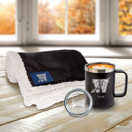 black sherpa blanket with blue patch and coffee mug