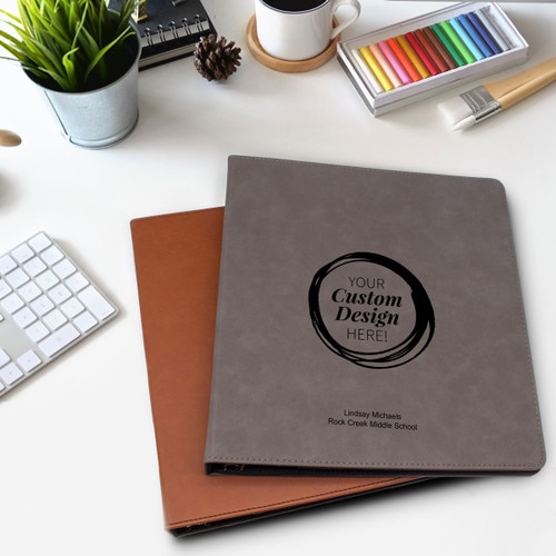 create your own rawhide and gray leather notebooks sitting on a desk