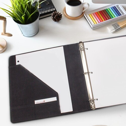 leather notebook sitting on a desk