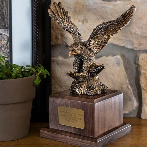 antique gold eagle award sitting on a mantle