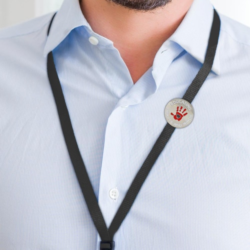 educating hearts and minds lapel pin an a black lanyard