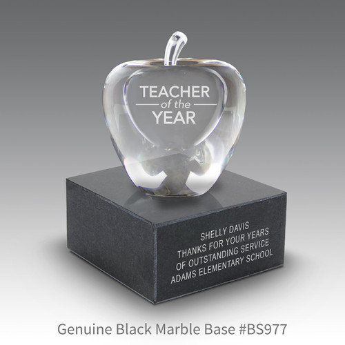 optic crystal apple with teacher of the year message sitting on top a black marble base