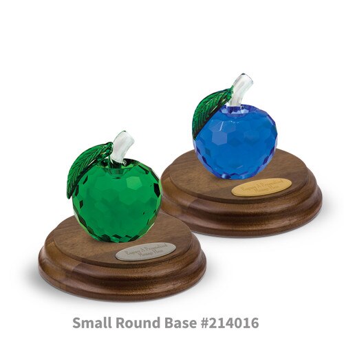 blue and green faceted crystal apples sitting on top of round walnut bases with brass and silver plates