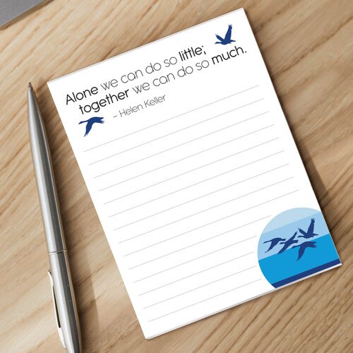 alone we can do so little notepad and silver pen sitting on a desk