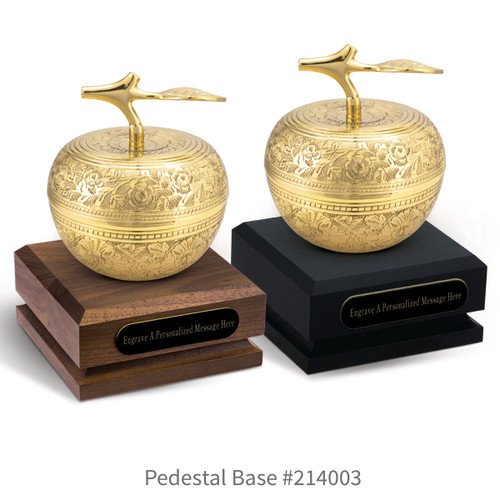 black and a brown walnut pedestal bases with black brass plates and gold embossed apple dishes