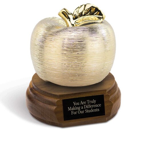 gold spun apple sitting on top a walnut base with black brass plate