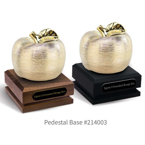 black and a brown walnut pedestal bases with black brass plates and gold spun apples
