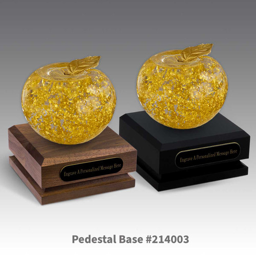 black and a brown walnut pedestal bases with black brass plates and handblown 23k gold apples
