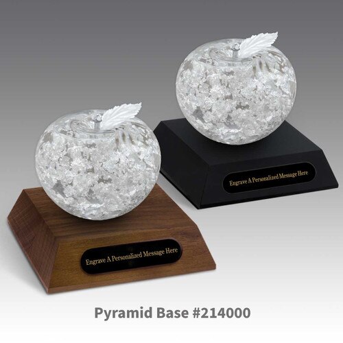 black and a brown walnut pyramid bases with black brass plates and handblown fine silver apples