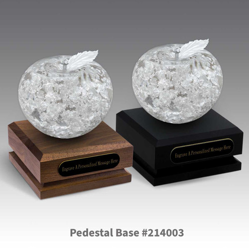 black and a brown walnut pedestal bases with black brass plates and handblown fine silver apples