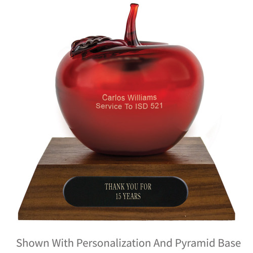 personalized red handblown glass apple sitting on top a walnut base with black brass plate