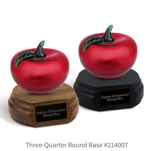 black and a brown walnut three-quarter round bases with black brass plates and red hanblown glass apples