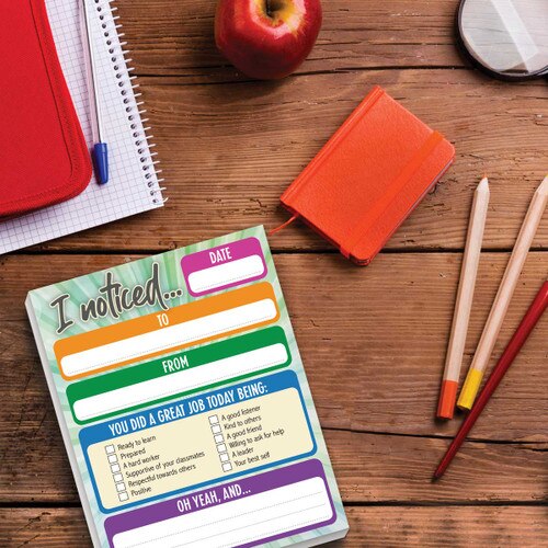 I noticed notepad with colored pencils, journal and apple