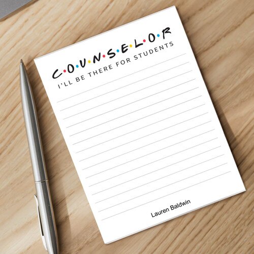 personalized notepad and silver pen sitting on a desk