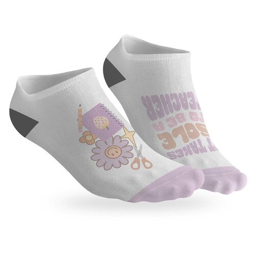 pair of no-show socks with a black heel and a it takes sole to be a teacher message on top