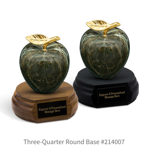 black and a brown walnut three-quarter round bases with black brass plates and green marble apples